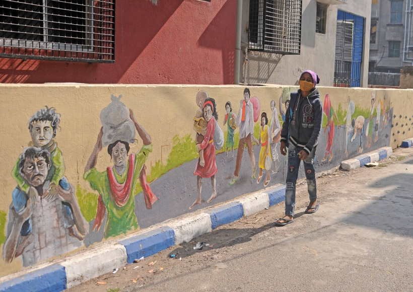 A girl walks past a wall Graffiti