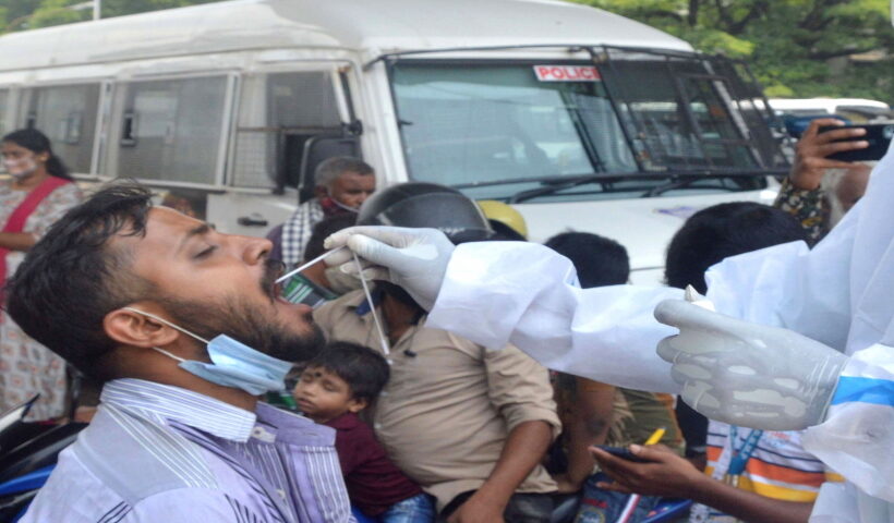 Health workers collect swab samples for COVID 19 tests