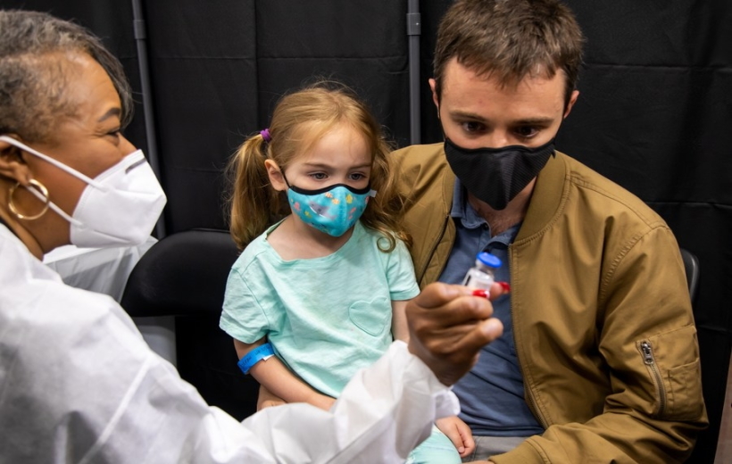 A healthcare worker shows a vial of the COVID-19 vaccine at a vaccination site in Times Square, New York, the United States,