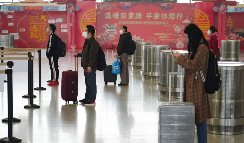 Passengers line up at a certain distance before checking-in at the Terminal 3 of Xianyang International Airport in Xi'an, northwest China's Shaanxi Province, Feb. 12, 2020. People are encouraged to line up with a distance of at least one meter with each other in recent days as a measure to prevent and control the epidemic