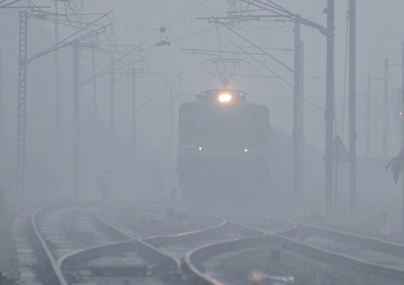 New Delhi: A train runs on a railway track amid dense fog on a cold day, in New Delhi on Monday