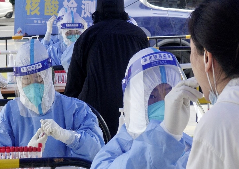 A medic takes swab samples from a resident for nucleic acid testing at Balizhuang subdistrict in Chaoyang District, Beijing, capital of China,