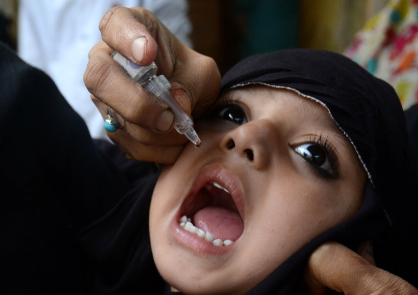 LAHORE, Oct. 24, 2016 (Xinhua) -- A Pakistani health worker gives a polio vaccine to a child on World Polio Day in eastern Pakistan's Lahore, Oct. 24, 2016. The World Polio Day was observed across the globe on Monday with renewed pledge to work with more dedication in enhancing awareness about the hazards of the crippling disease