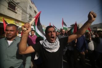 Palestinian people protest against the flag march in East Jerusalem, on May 29, 2022