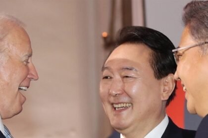 South Korean President Yoon Suk-yeol (C) talks with U.S. President Joe Biden