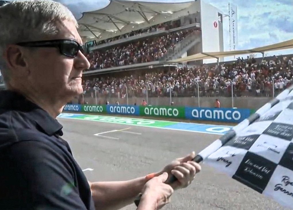 Apple CEO Tim Cook checkered flag at Formula one GP