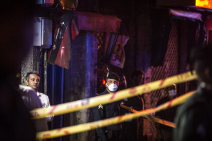 An Iranian policeman stands guard at the explosion site in Tehran