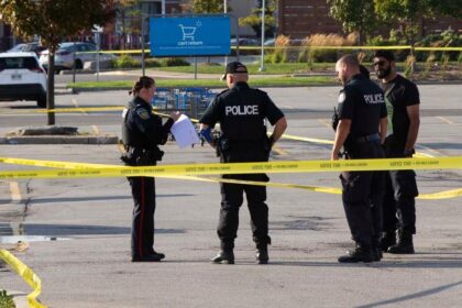 Police officers are seen at the scene investigating on the double shootings in Mississauga