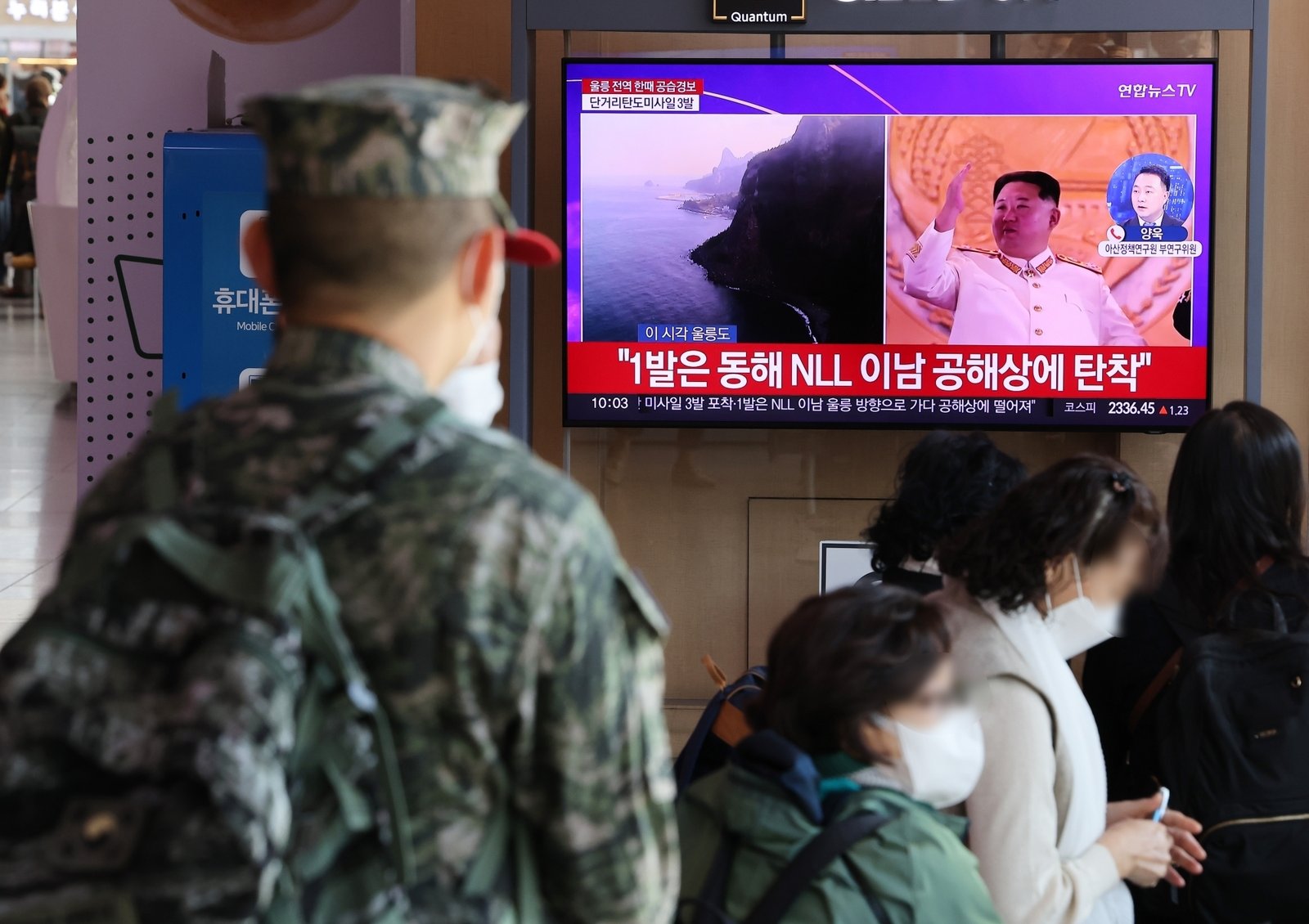A soldier watches a TV report at Seoul Station