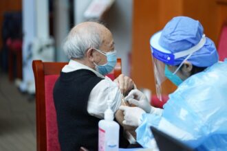 A medical worker injects COVID-19 vaccine for a senior citizen in Dongcheng District of Beijing