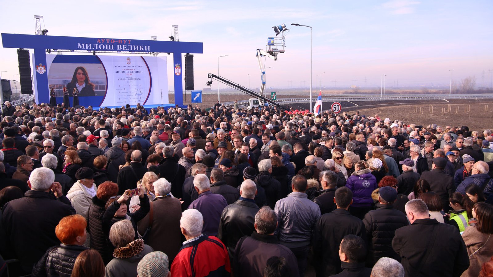 People attend the opening ceremony of a highway section in Belgrade