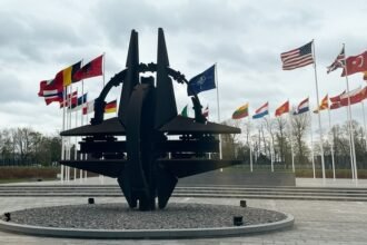 A sculpture and flags at NATO headquarters in Brussels
