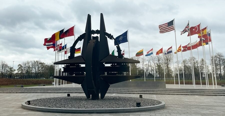 A sculpture and flags at NATO headquarters in Brussels
