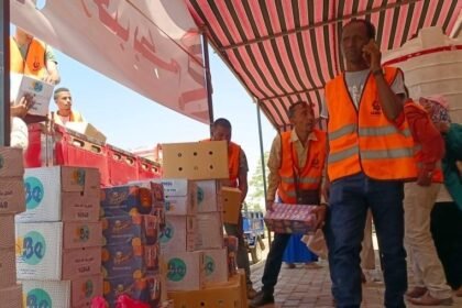 Staff members prepare supplies for refugees from Sudan