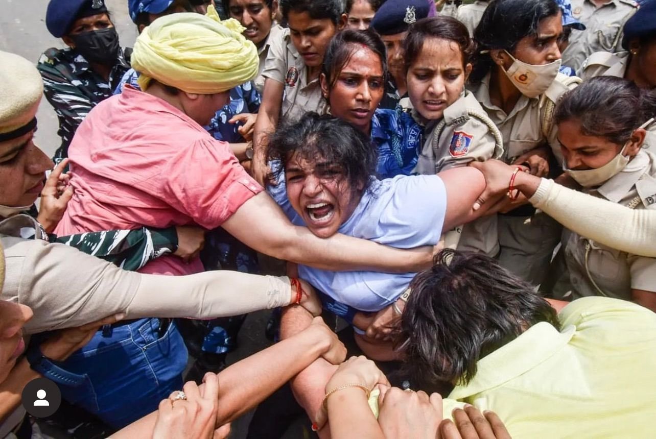 Wrestler Sakshi Malik being detained by police during wrestlers' protest